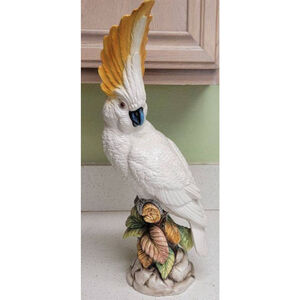This is a porcelain cockatoo figurine, likely made by Andrea by Sadek.